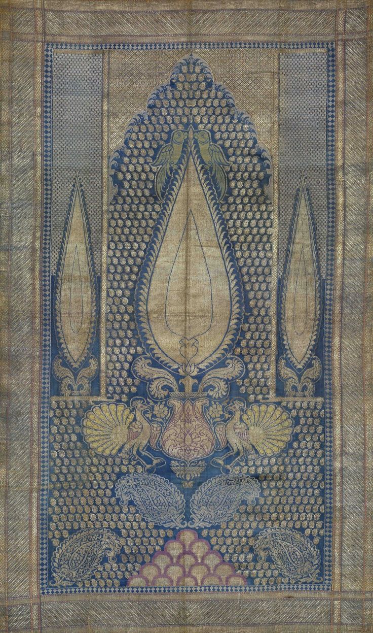 Decorative fabric panel with intricate blue and beige pattern on a textured background