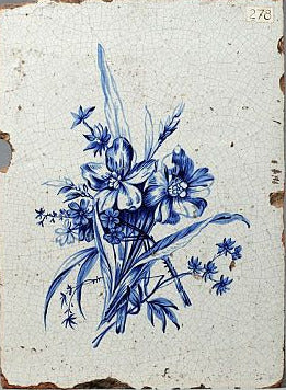 Dutch Delft blue tile with floral design on a white background
