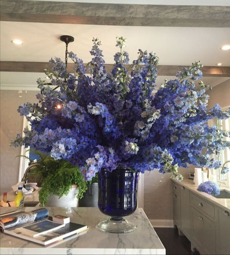 Large blue floral arrangement in a modern kitchen setting